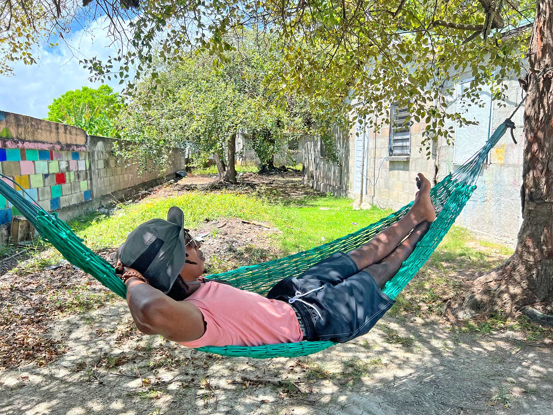Cyril Uruwei relaxing in a hammock - The Belize Well Nest Program